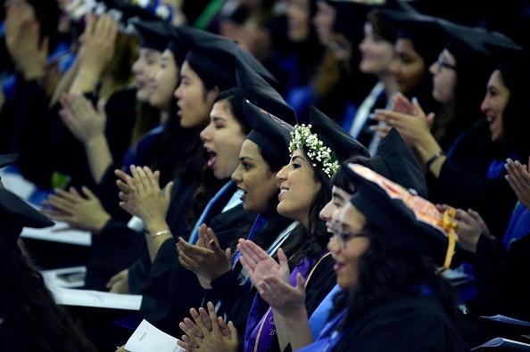 Students listen as Hillary Clinton speaks at commencement at Wellesley College May 26, 2017, in Wellesley, Massachusetts.